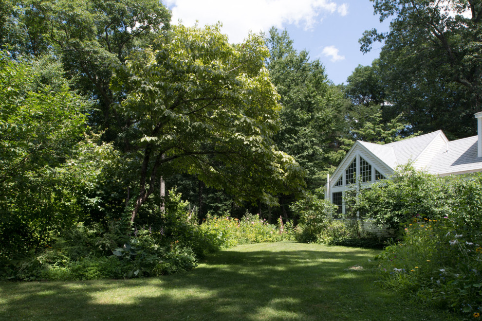 Design ideas for a medium sized rural back xeriscape partial sun garden in Boston.