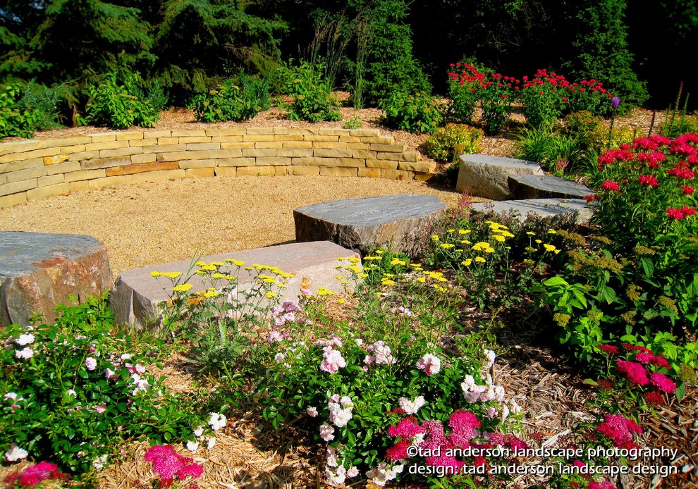 Photo of a bohemian back garden for summer in Minneapolis with a retaining wall and gravel.