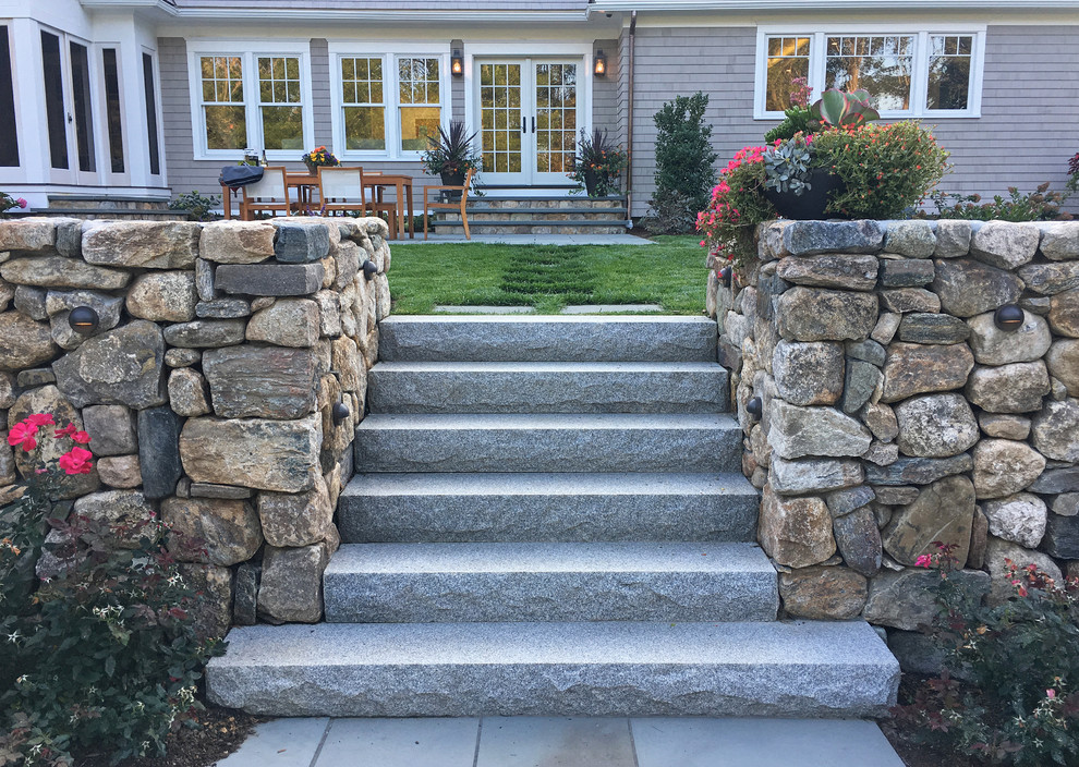 Traditional front full sun garden for summer in Boston with a retaining wall and natural stone paving.