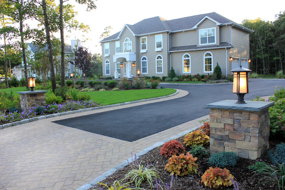 Large nautical front driveway full sun garden in New York with concrete paving.