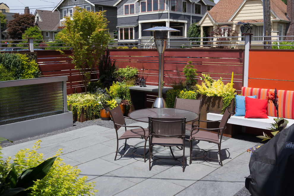 This is an example of a small contemporary back partial sun garden for summer in Seattle with an outdoor sport court and natural stone paving.
