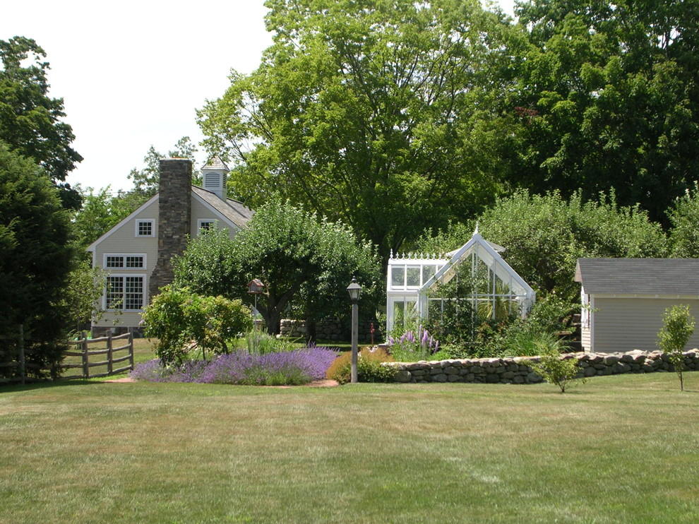 Design ideas for a large farmhouse full sun backyard brick formal garden in Boston for summer.