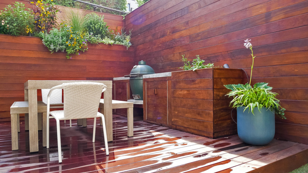 Inspiration for a small contemporary back private full sun garden in New York with decking.