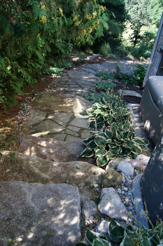 Photo of a large rustic partial sun front yard mulch garden path in Detroit for summer.