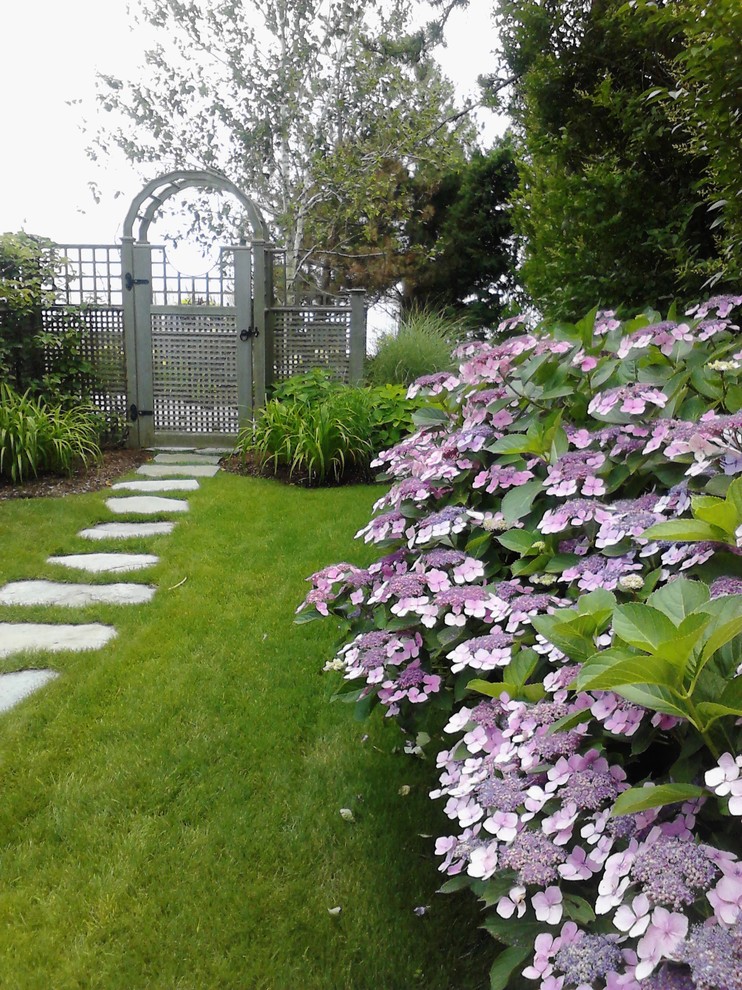 Nautical side fully shaded garden for summer in Bridgeport with a garden path and natural stone paving.