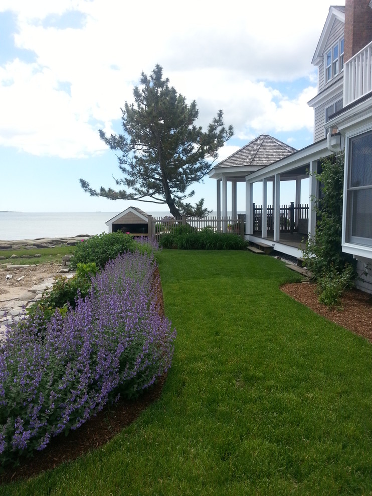 This is an example of a beach style side full sun garden for summer in Bridgeport with a garden path.