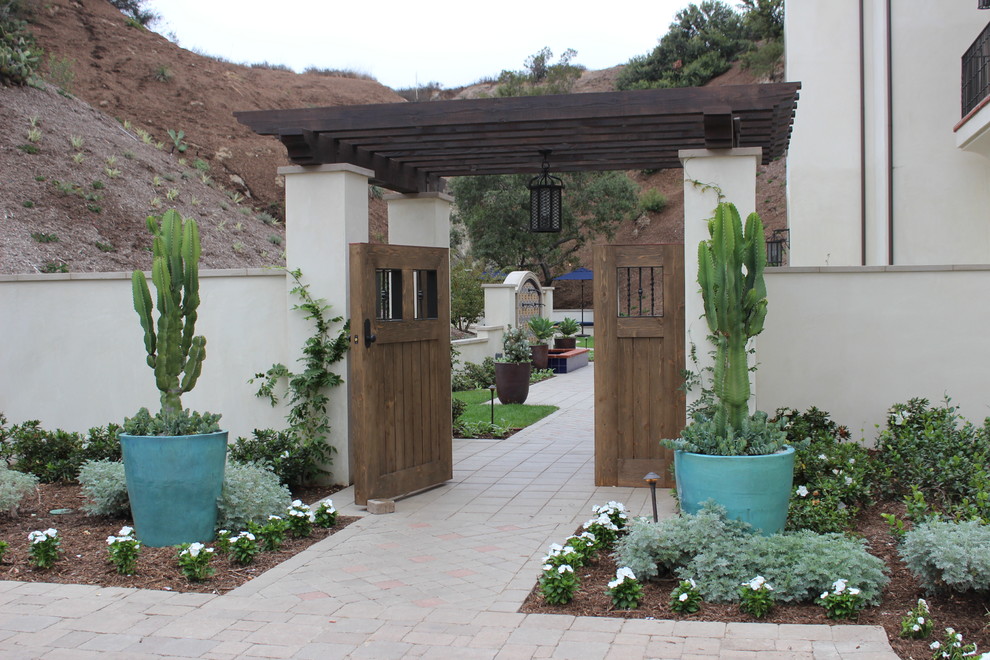 Esempio di un giardino xeriscape american style esposto a mezz'ombra in cortile e di medie dimensioni con un ingresso o sentiero e pavimentazioni in cemento
