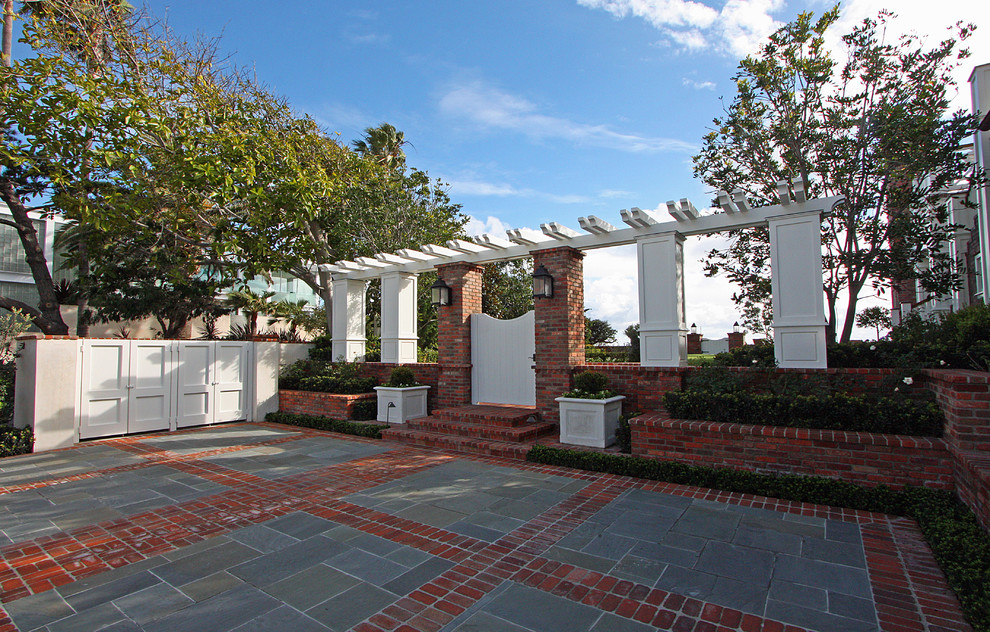 Photo of a traditional courtyard brick landscaping in Orange County.