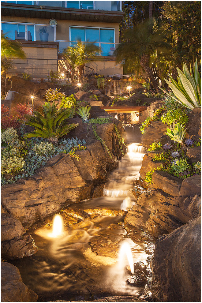 Inspiration for a tropical full sun water fountain landscape in Los Angeles.