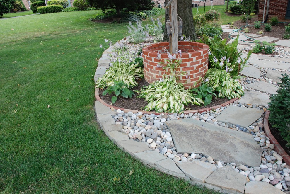 This is an example of a mid-sized traditional partial sun backyard stone garden path in Other.