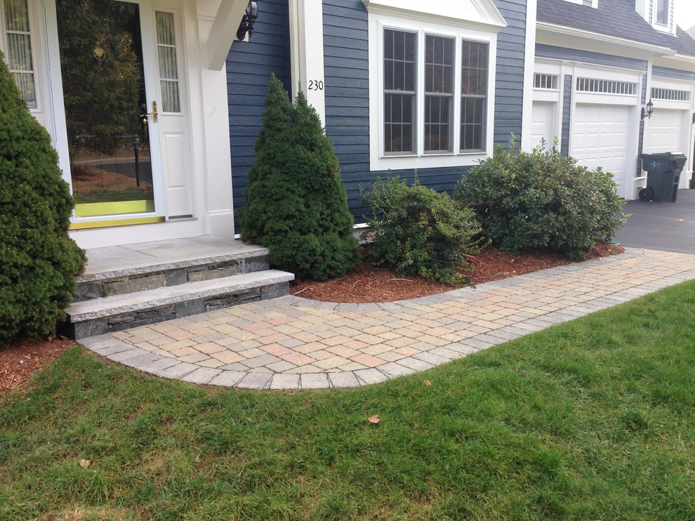 Photo of a large traditional front garden in Boston with a garden path and concrete paving.