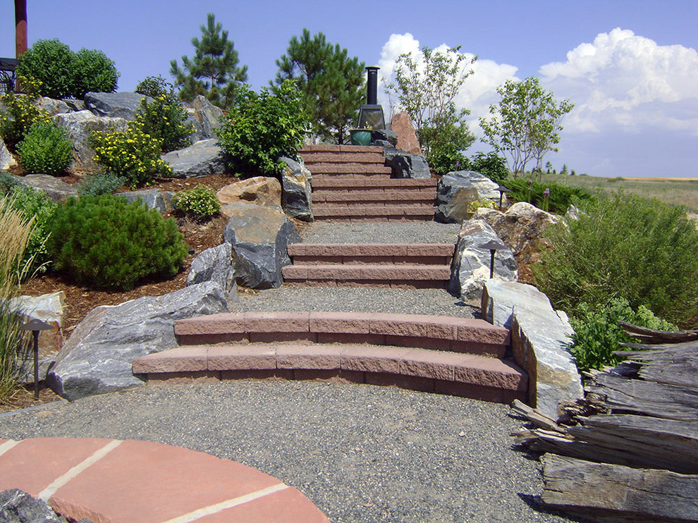 Photo of a large traditional back xeriscape full sun garden in Denver with a garden path and gravel.