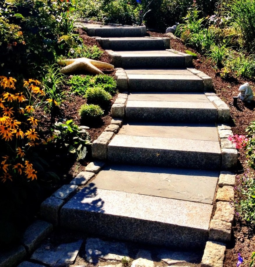Small nautical back formal partial sun garden for summer in Portland Maine with a garden path and natural stone paving.