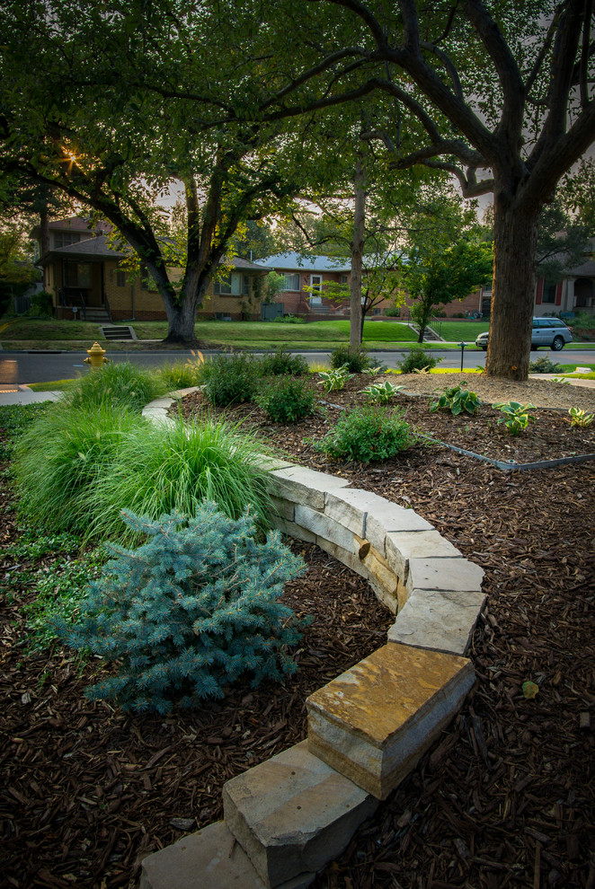 Inspiration for a mid-sized contemporary front yard stone retaining wall landscape in Denver.