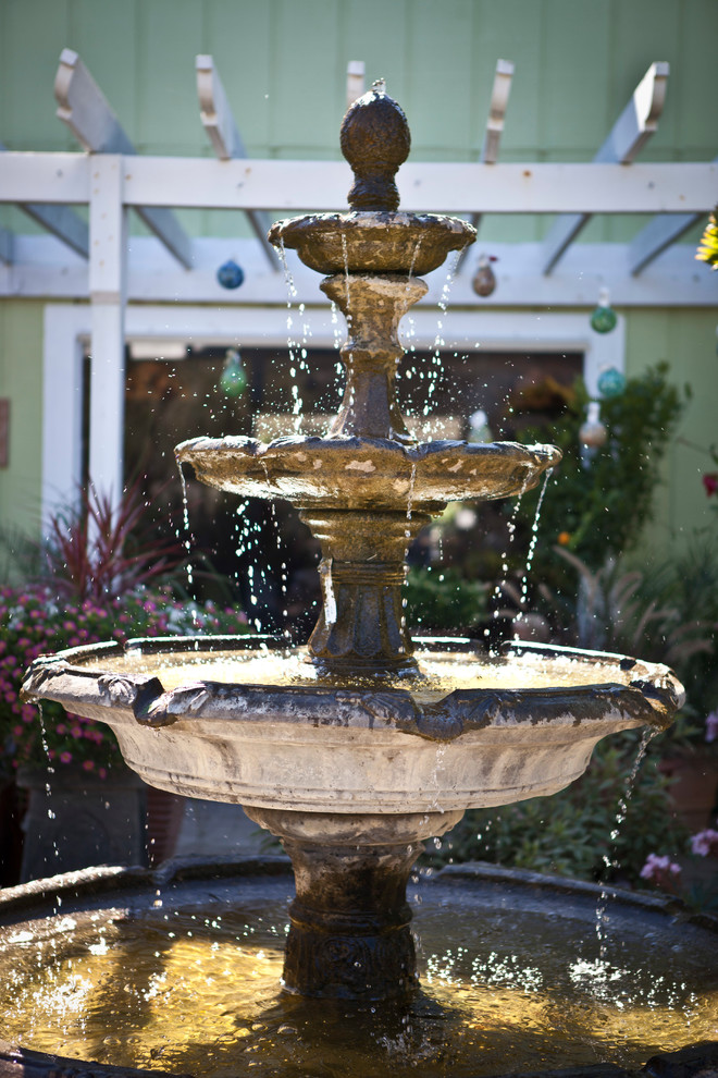 This is an example of a mediterranean courtyard brick water fountain landscape in Miami.