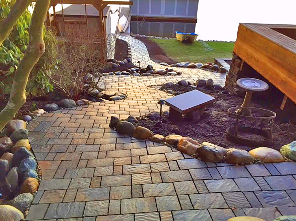 This is an example of a mid-sized contemporary partial sun side yard concrete paver landscaping in Seattle for summer.
