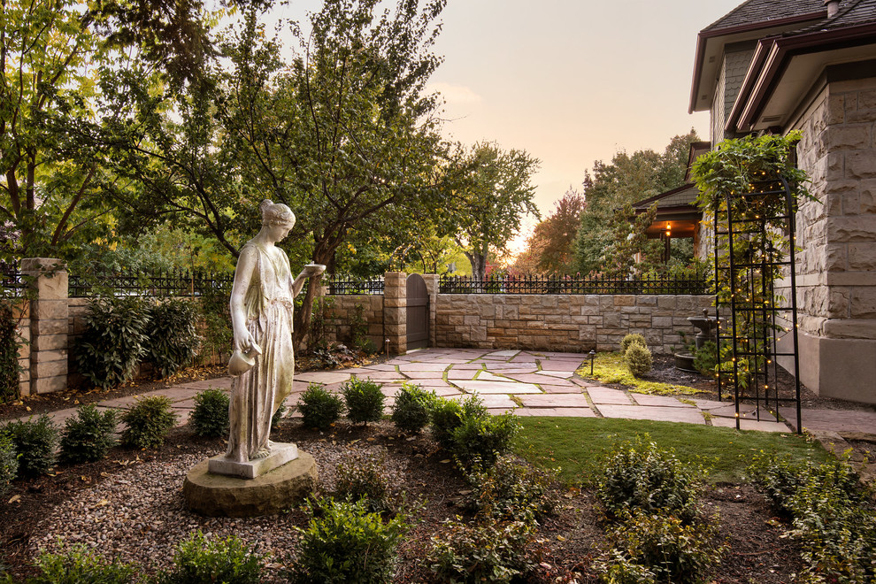 This is an example of a mid-sized victorian full sun backyard stone landscaping in Boise for winter.