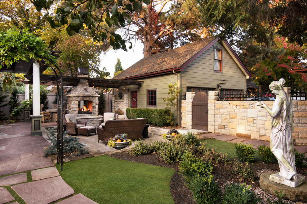 Photo of a mid-sized victorian partial sun backyard stone formal garden in Boise with a fire pit.