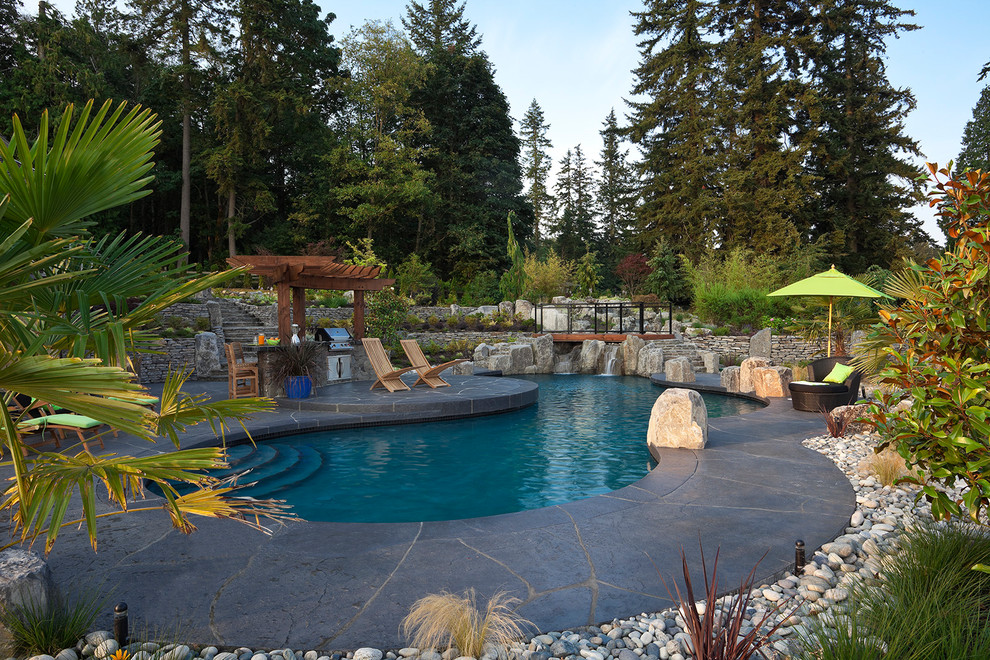 Expansive modern sloped formal full sun garden for summer in Vancouver with natural stone paving.