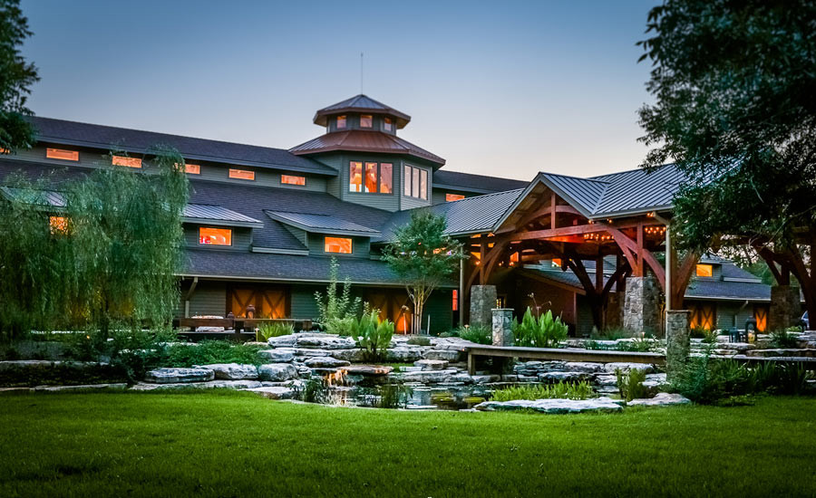 Photo of an expansive rural garden in Houston with natural stone paving and a pond.