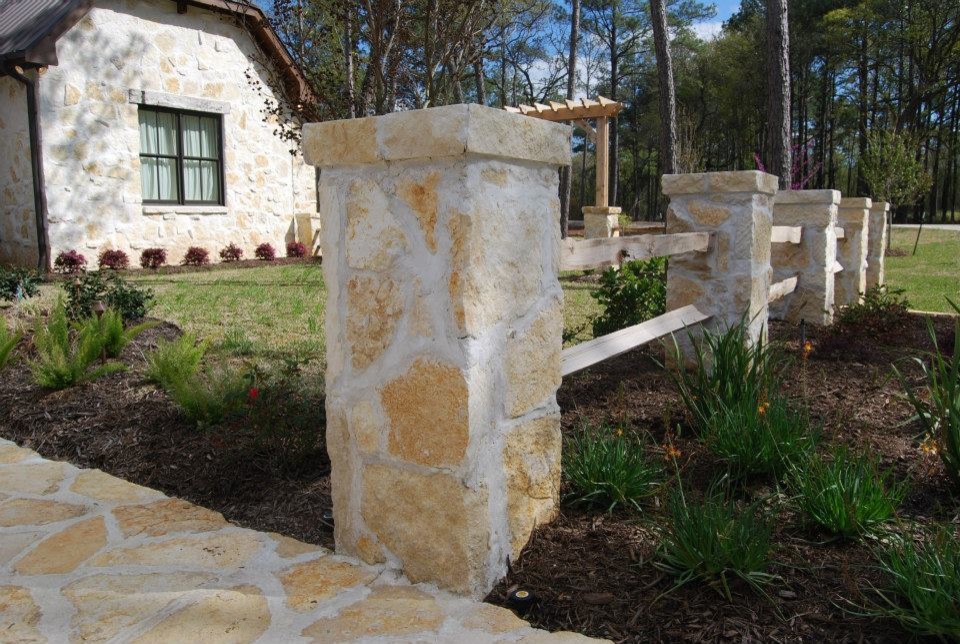 Inspiration for a huge rustic partial sun stone landscaping in Houston.