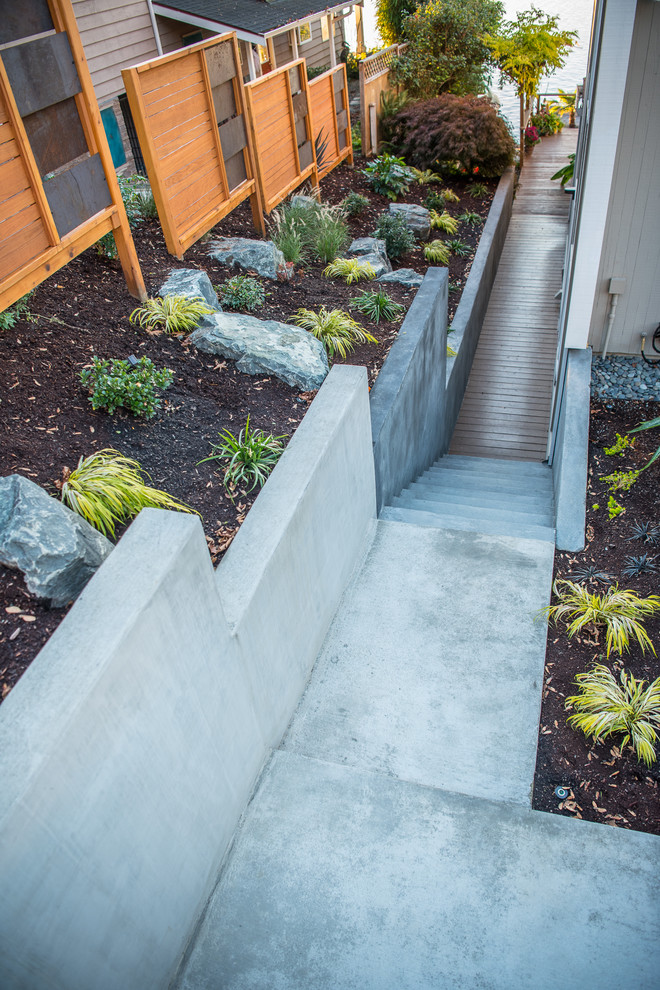 Inspiration for a medium sized modern front garden in Seattle with a retaining wall and concrete paving.