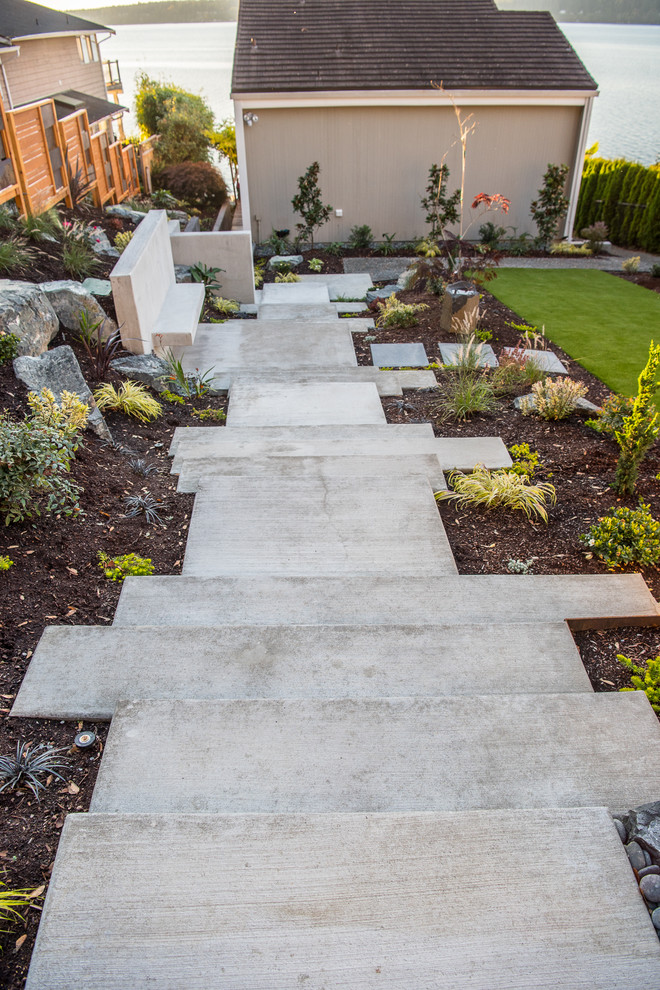 Inspiration for a mid-sized modern front yard concrete paver retaining wall landscape in Seattle.