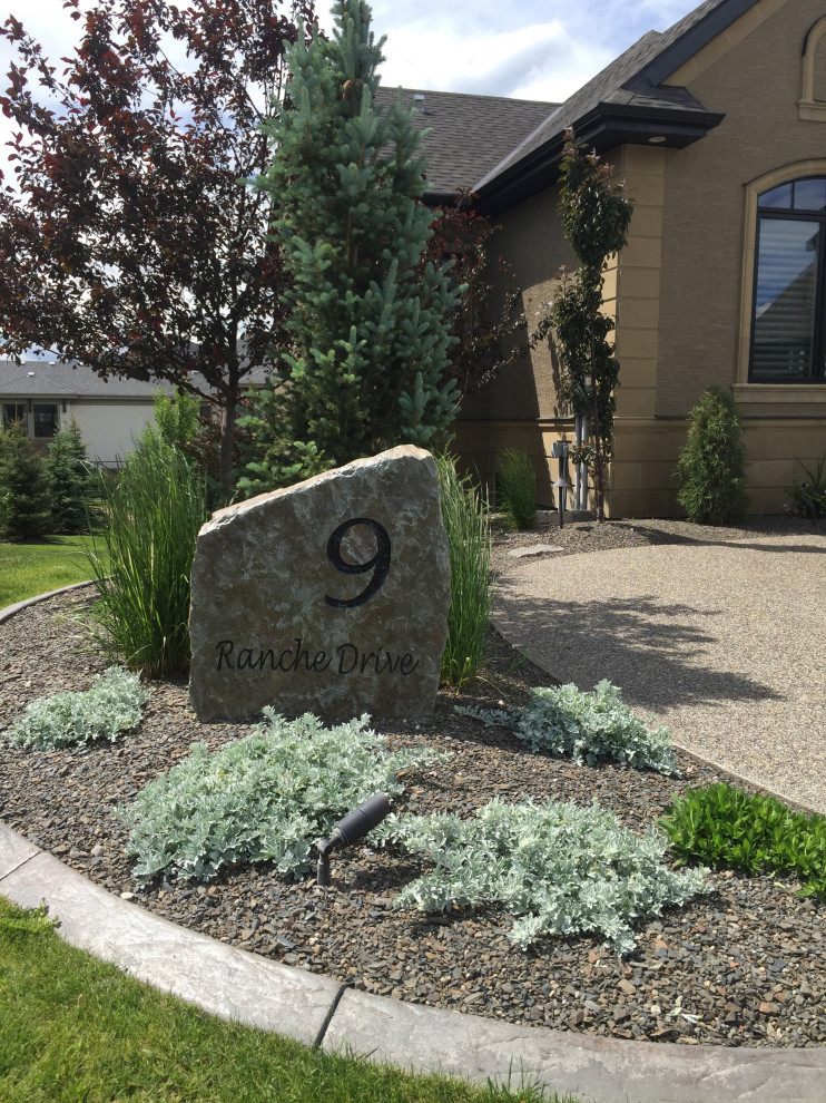 Design ideas for a large front garden in Calgary with a desert look and decomposed granite.