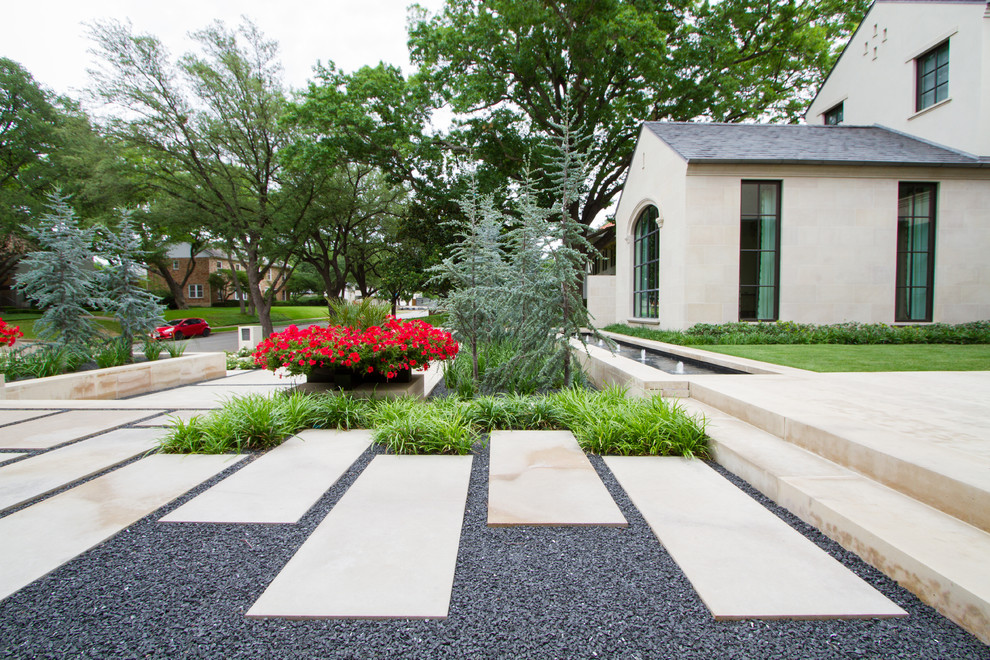 Photo of a mid-sized contemporary full sun front yard stone landscaping in Dallas for spring.