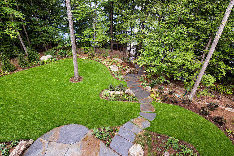 Design ideas for a medium sized contemporary back partial sun garden in Burlington with natural stone paving.