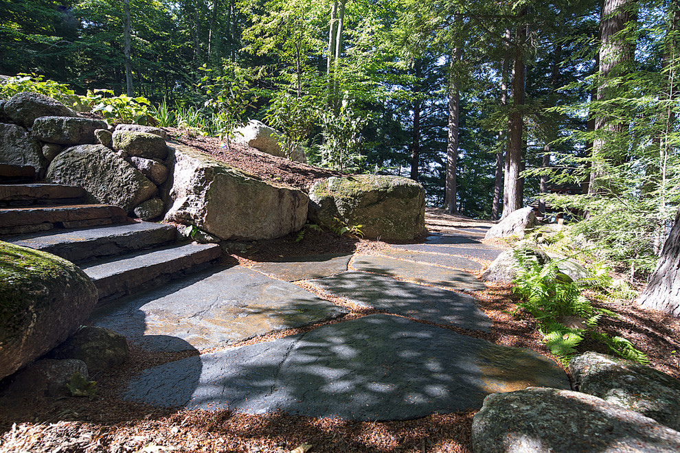 Design ideas for a medium sized contemporary back partial sun garden in Burlington with natural stone paving.