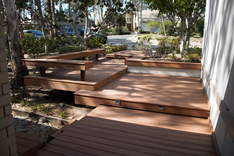 This is an example of a large contemporary back full sun garden for summer in Los Angeles with an outdoor sport court, a retaining wall and decking.