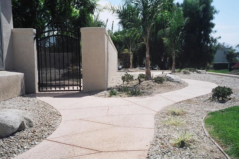 Photo of a medium sized classic front xeriscape full sun garden for summer in Santa Barbara with a garden path and natural stone paving.