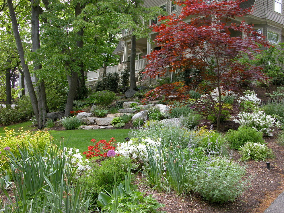 Photo of a medium sized traditional front partial sun garden for spring in Boston with a garden path and natural stone paving.