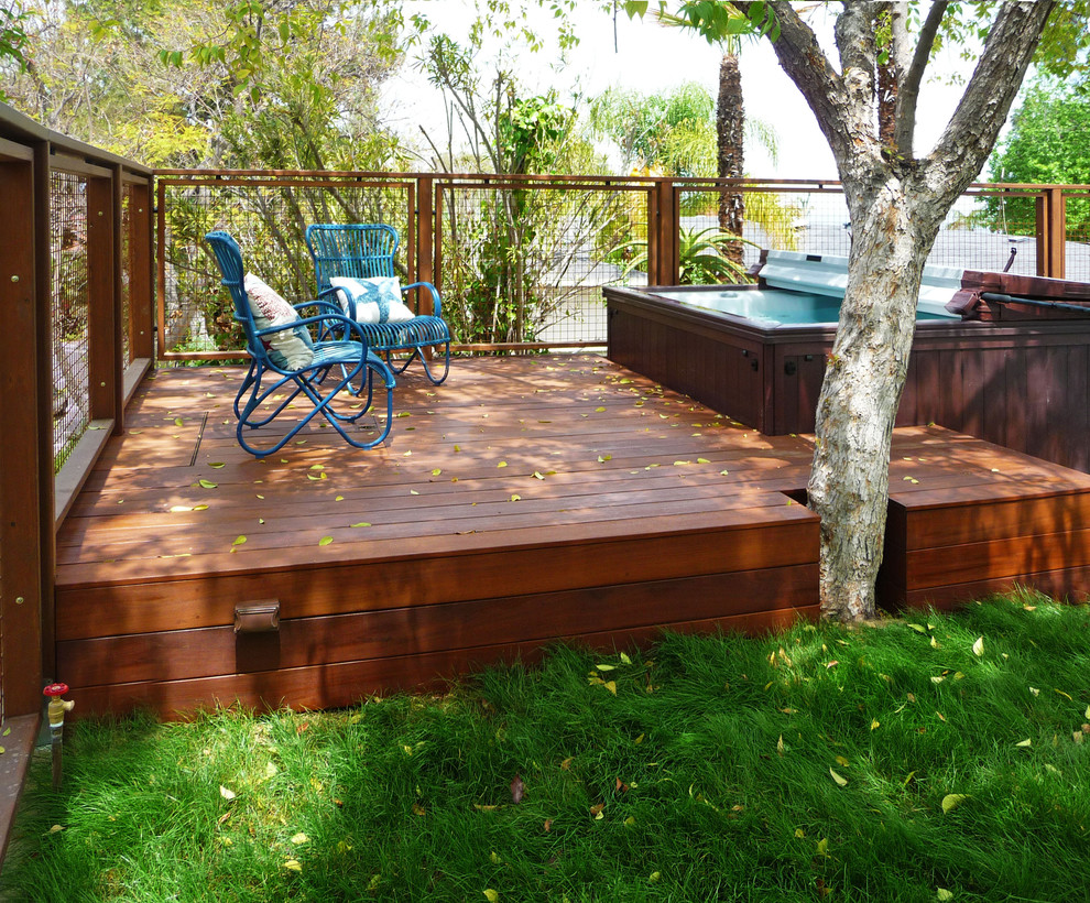 Photo of a large modern shade backyard water fountain landscape in Los Angeles with decking.