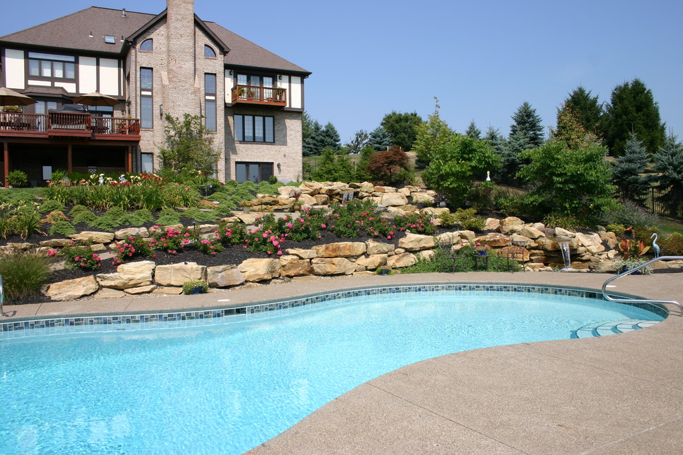 This is an example of a huge contemporary full sun backyard concrete paver water fountain landscape in Other for summer.