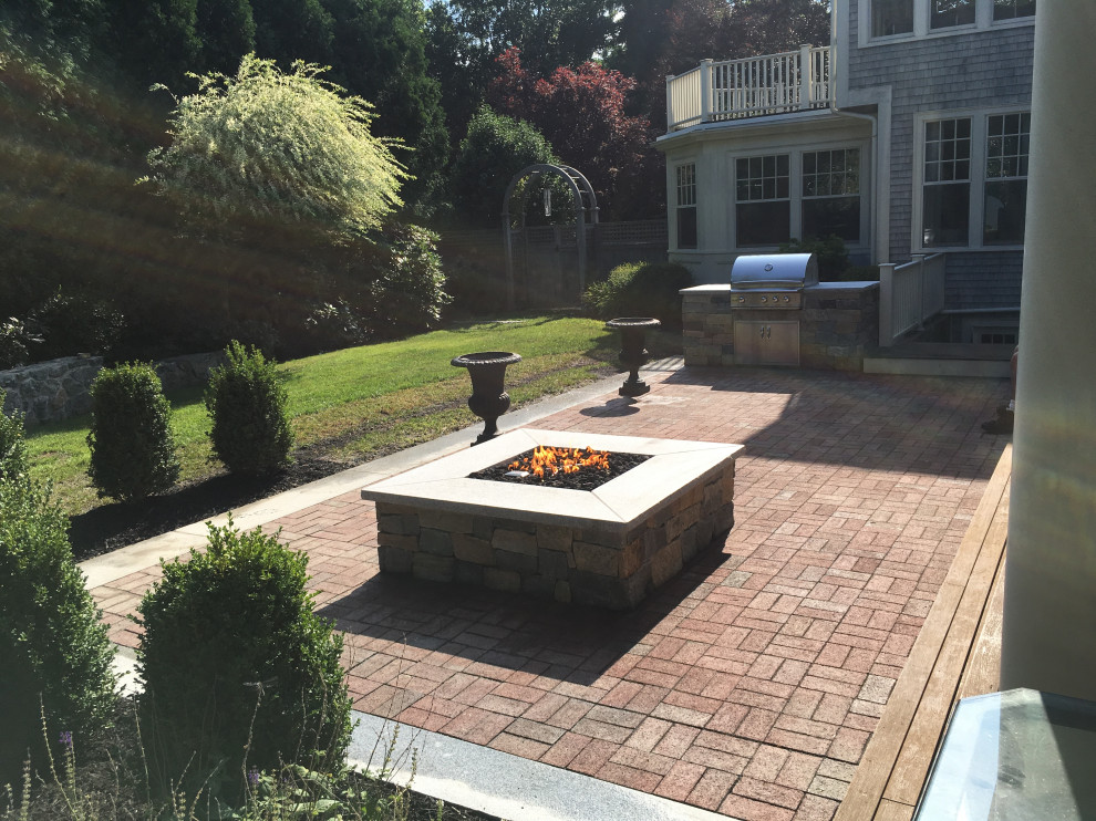 Hingham brick patio framed by granite and outdoor kitchen
