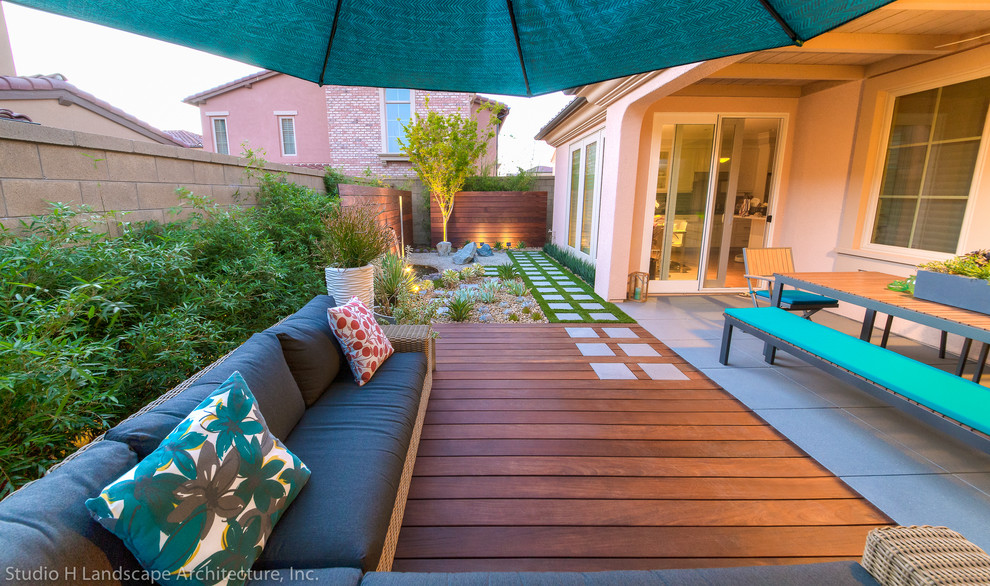 Photo of a small contemporary side xeriscape partial sun garden in Orange County with a garden path and decking.