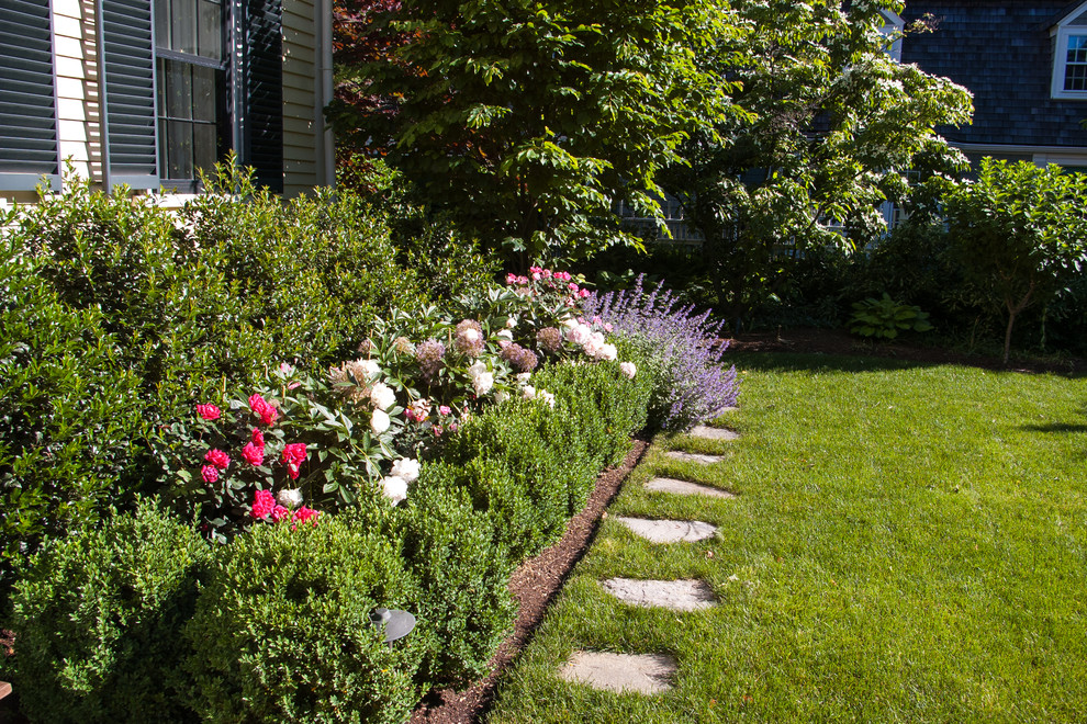 Esempio di un giardino classico esposto in pieno sole di medie dimensioni e davanti casa con un ingresso o sentiero e pavimentazioni in pietra naturale