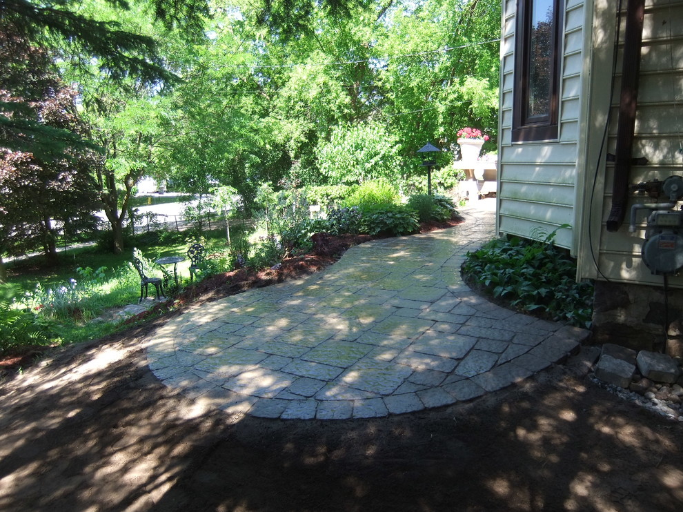 This is an example of a large partial sun front yard stone landscaping in Toronto for summer.