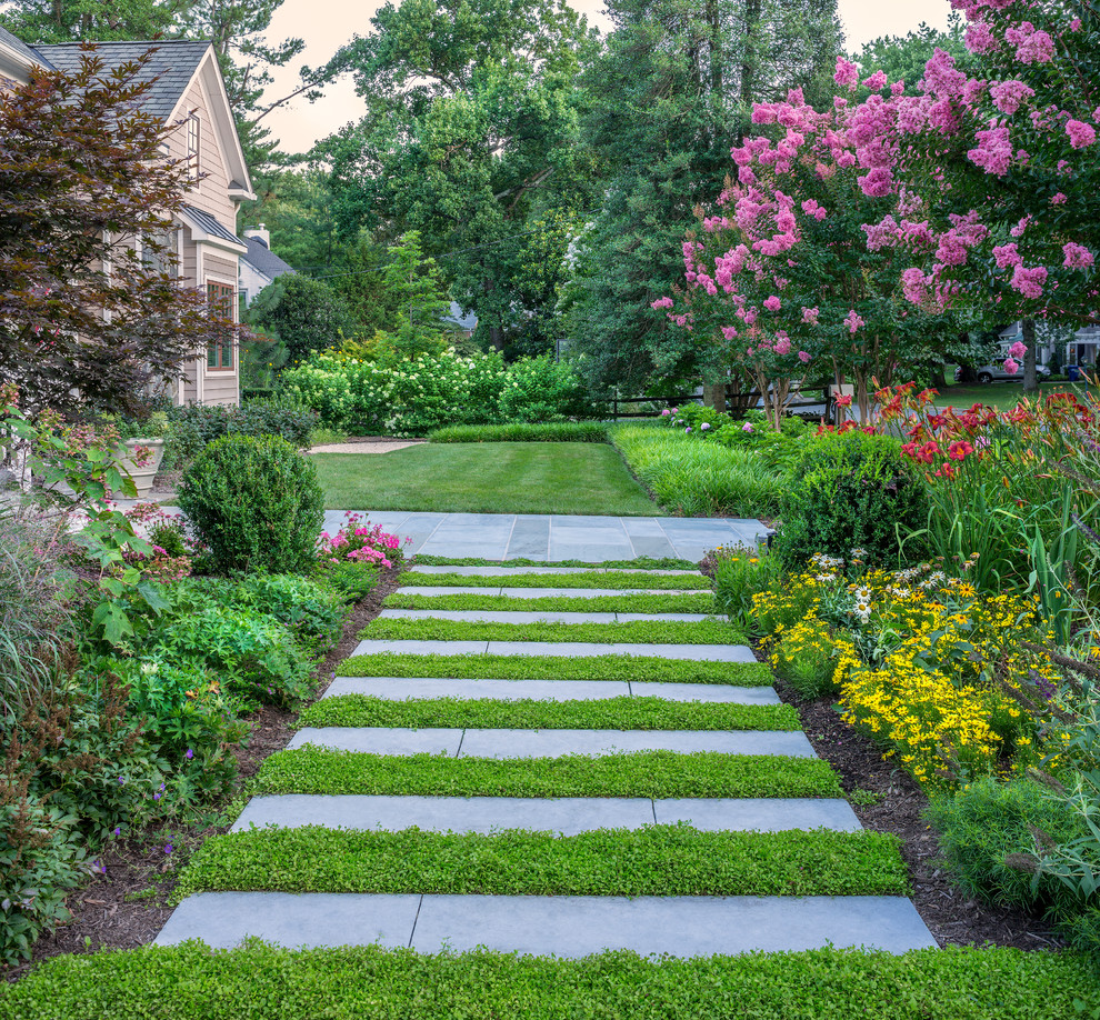 На фото: регулярный сад на переднем дворе в классическом стиле с садовой дорожкой или калиткой
