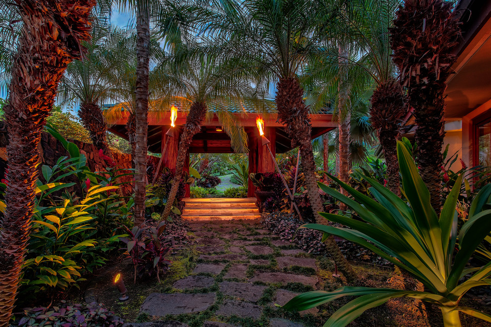 Expansive world-inspired formal partial sun garden for summer in Hawaii with a garden path.