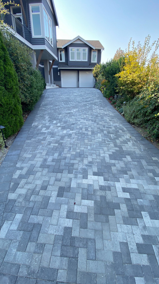 Large driveway garden in Seattle with concrete paving.