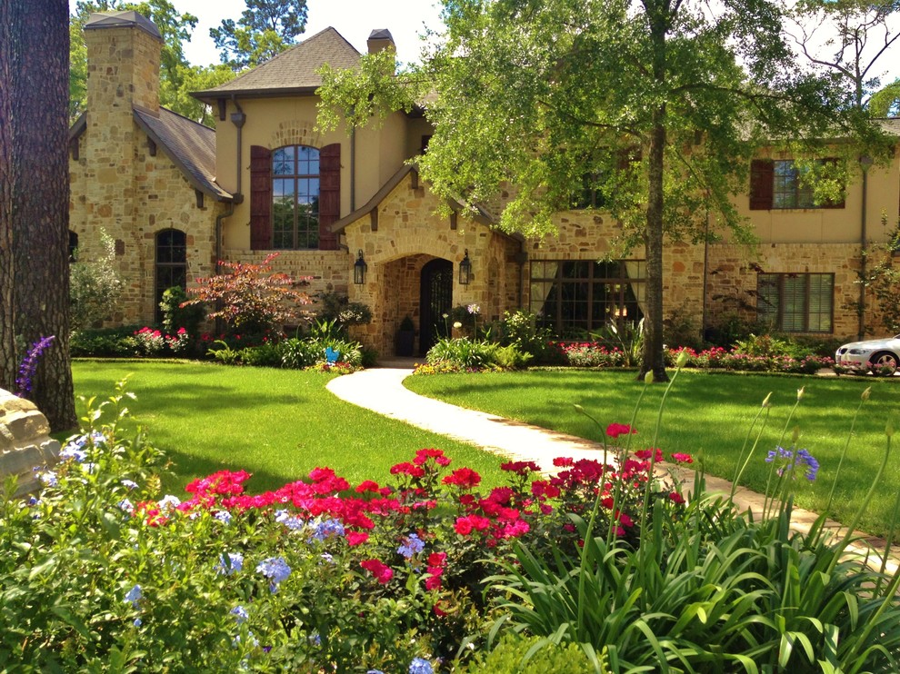 Стильный дизайн: большой солнечный, весенний регулярный сад на переднем дворе в классическом стиле с садовой дорожкой или калиткой, хорошей освещенностью и мощением клинкерной брусчаткой - последний тренд