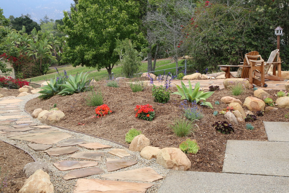 Imagen de jardín de secano mediterráneo grande en patio trasero con exposición total al sol y adoquines de piedra natural