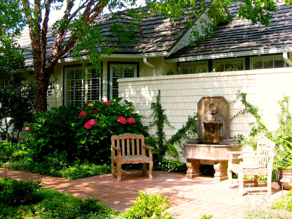 Photo of a classic back partial sun garden in Santa Barbara with a water feature.