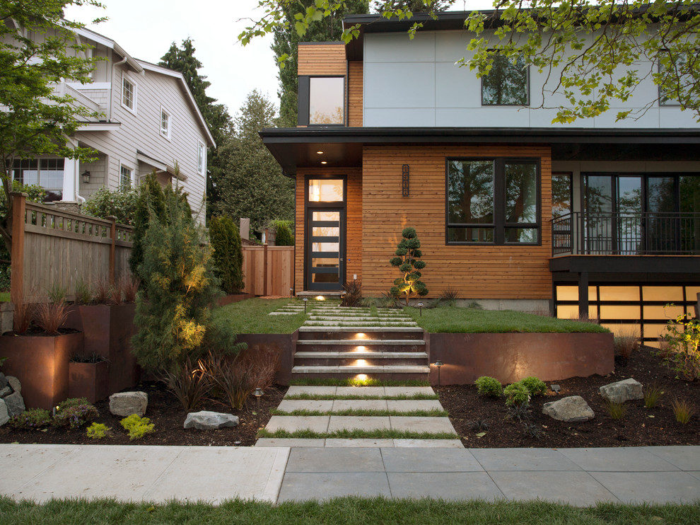 Inspiration for a medium sized modern front driveway full sun garden for spring in Seattle with a retaining wall and brick paving.