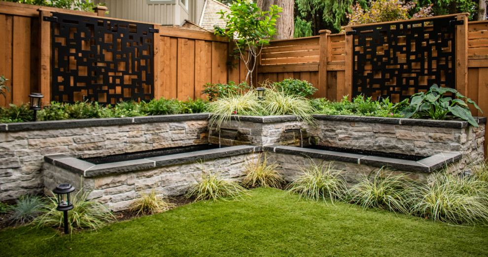 Medium sized contemporary back garden in Vancouver with a waterfall.