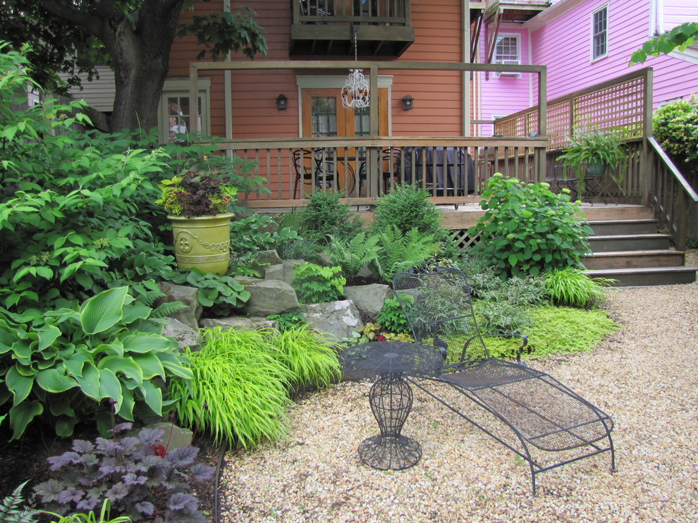Small contemporary back fully shaded garden for spring in New York with gravel.