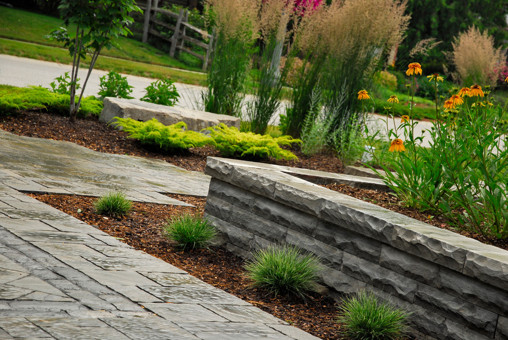 This is an example of a mid-sized craftsman full sun front yard concrete paver garden path in Toronto for summer.